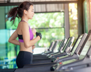 gym member running on treadmill